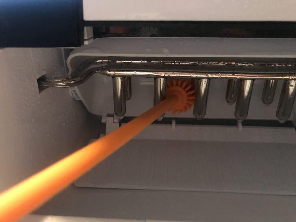 Use a brush to reach places you can't with a cloth on a portable ice maker