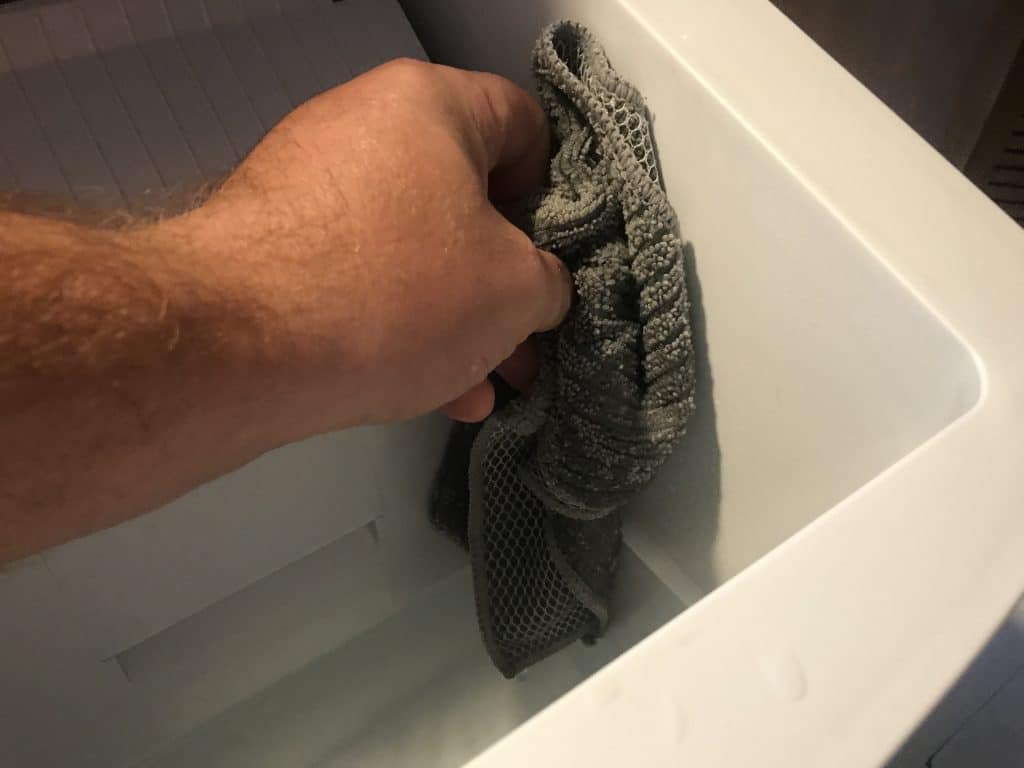 Wipe down the sides of the ice maker with a cloth
