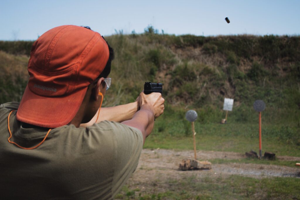 A guy shooting a target paper at a distance