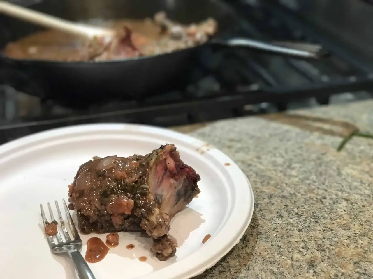 A plate with a fork and a meat dish.