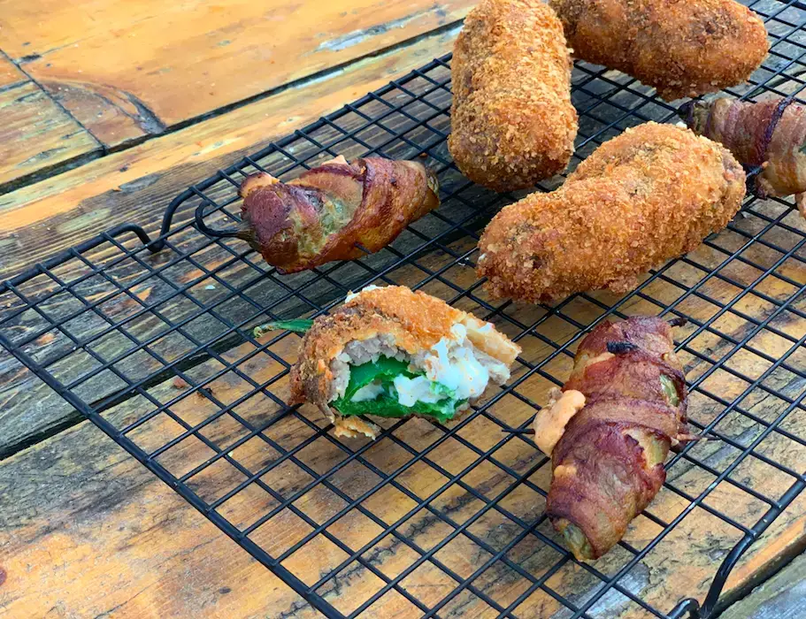 Jalapeno Poppers Fried jalapeno poppers on wire rack.