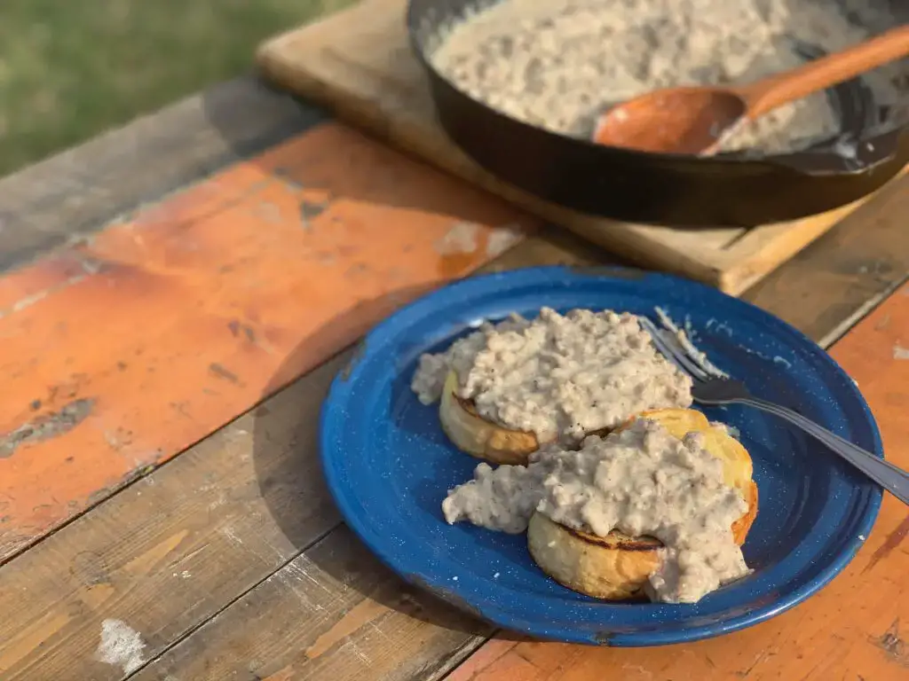 S.O.S. – $h!% on a Shingle Two biscuits with gravy on a blue plate.