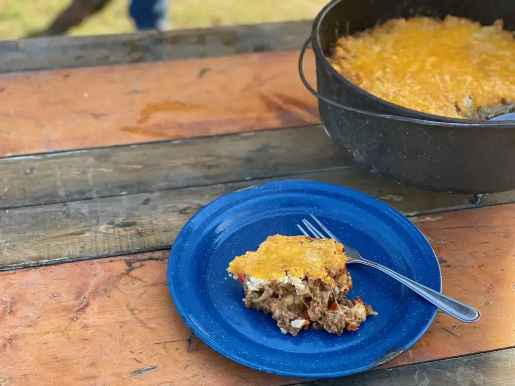 Cast Iron Tamale Pie A slice of cheesy casserole on a blue plate.