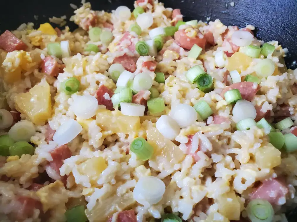 Fried rice with pineapple, ham, and green onions.