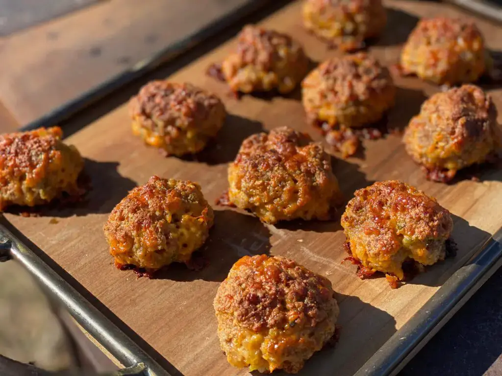 A tray of meatballs on top of a wooden surface.