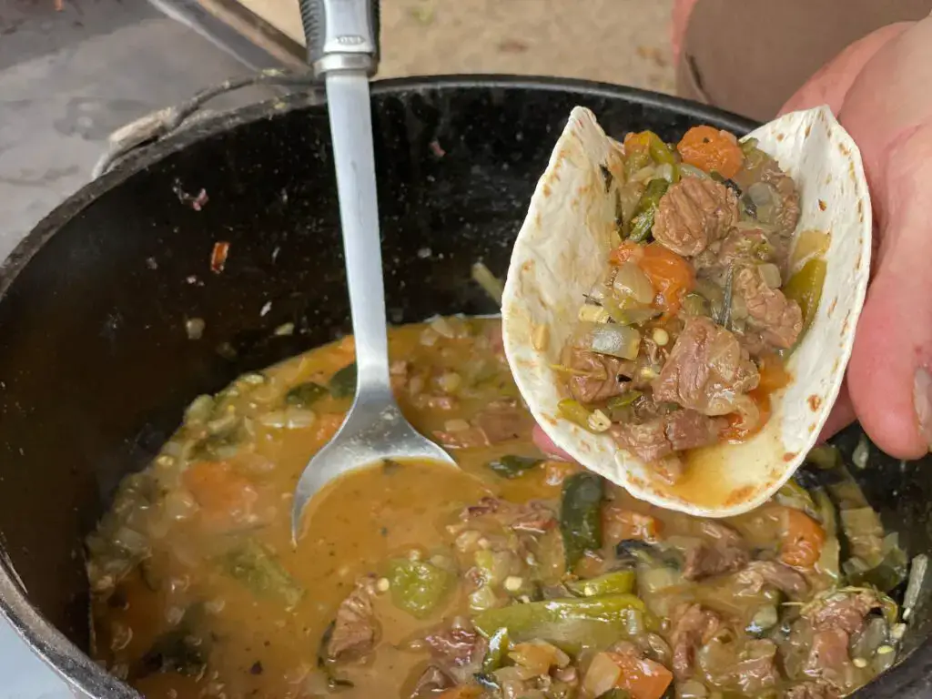 carneasada1-1024x768 A person is stirring some stew in a pot