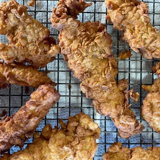 chickentenders A close up of some fried food on a grill