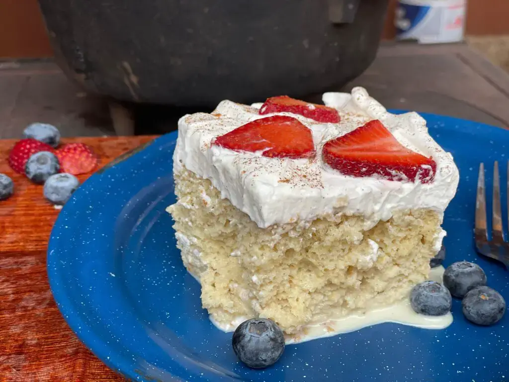 A piece of cake with strawberries on top.