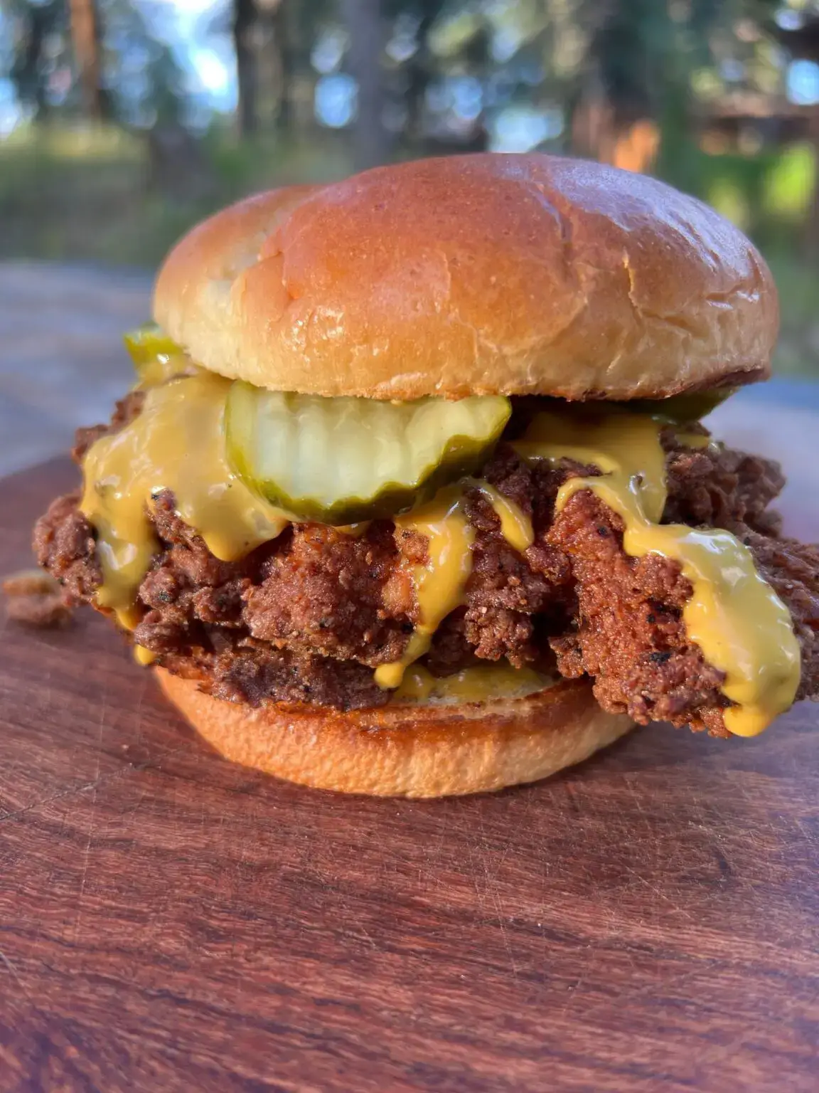 CrispyChickenFeat-1152x1536 A hamburger with pickles and mustard on it.