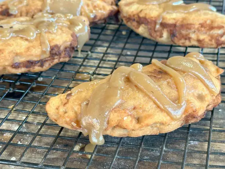 Fried pastry with caramel glaze on a wire rack.