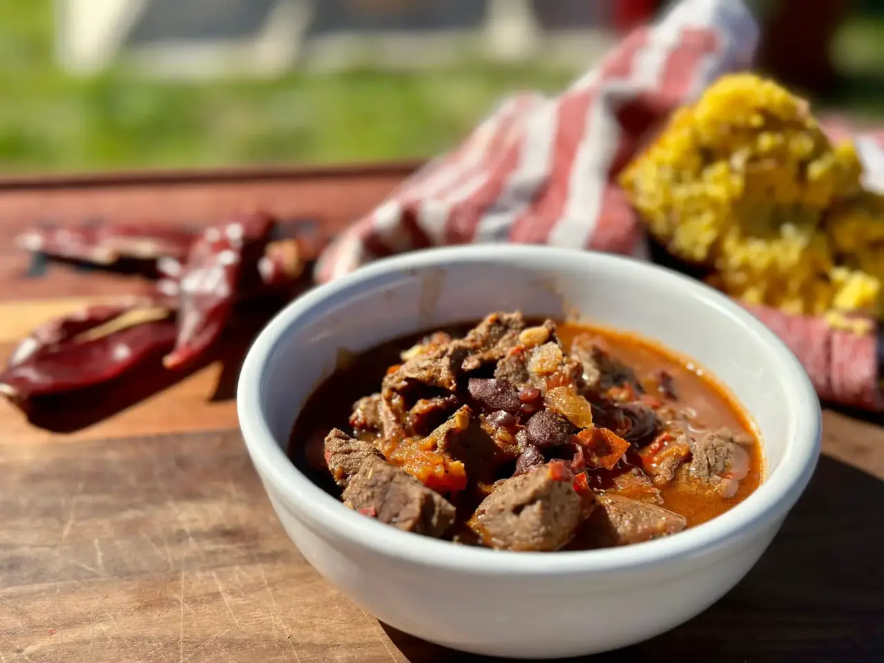 A bowl of chili with beans and corn.