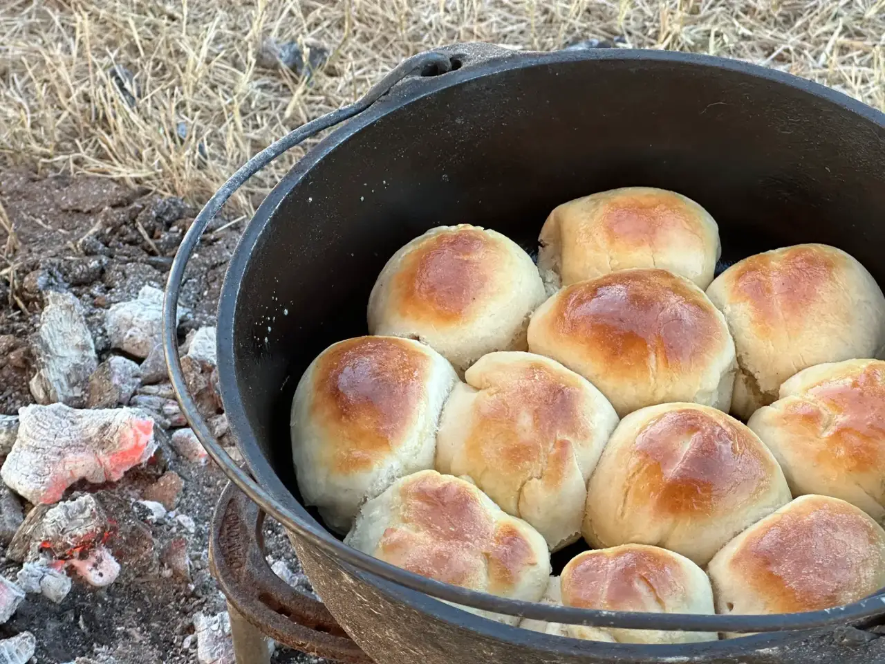 A pot of bread sitting on top of the ground.