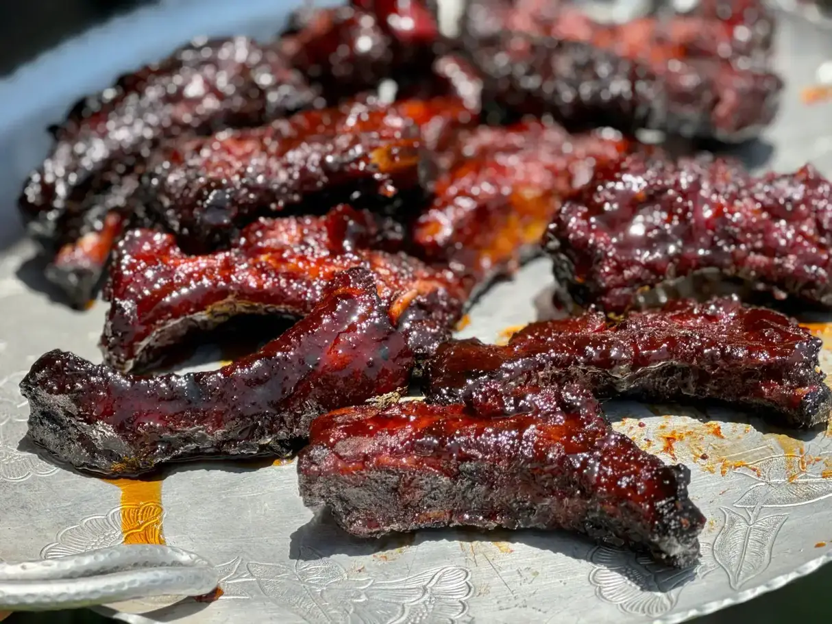 Glazed BBQ ribs on a tray.