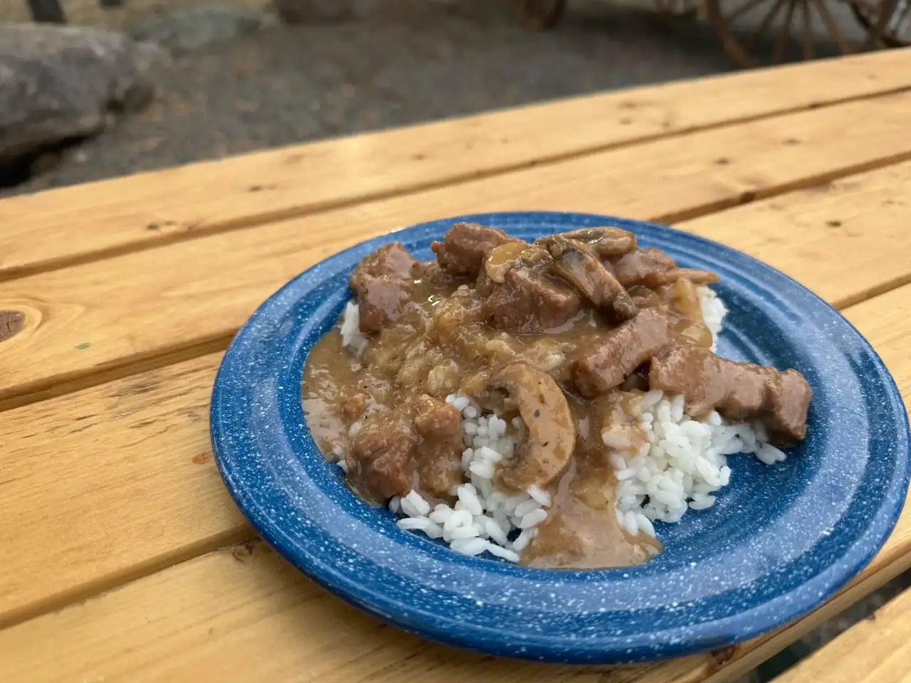 Cowboy Kent Rollins beef tips and rice on a blue enamel plate