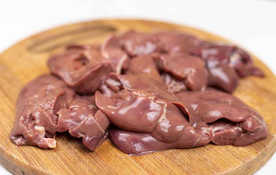 raw chicken liver on a chopping board